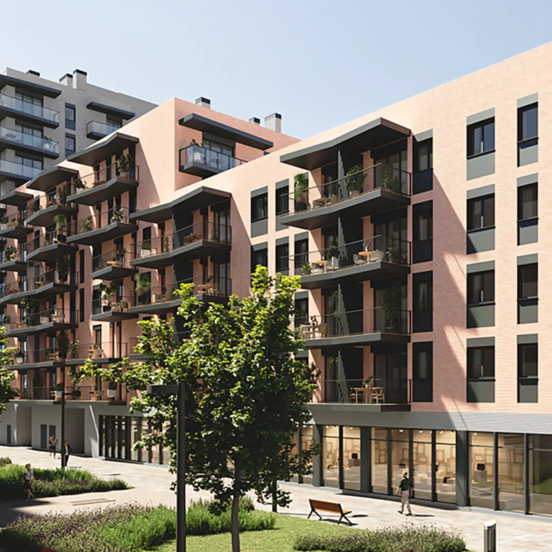 Edificio sostenible en Barcelona con diseño moderno y certificación energética. Construcción optimizada con balcones y espacios verdes.